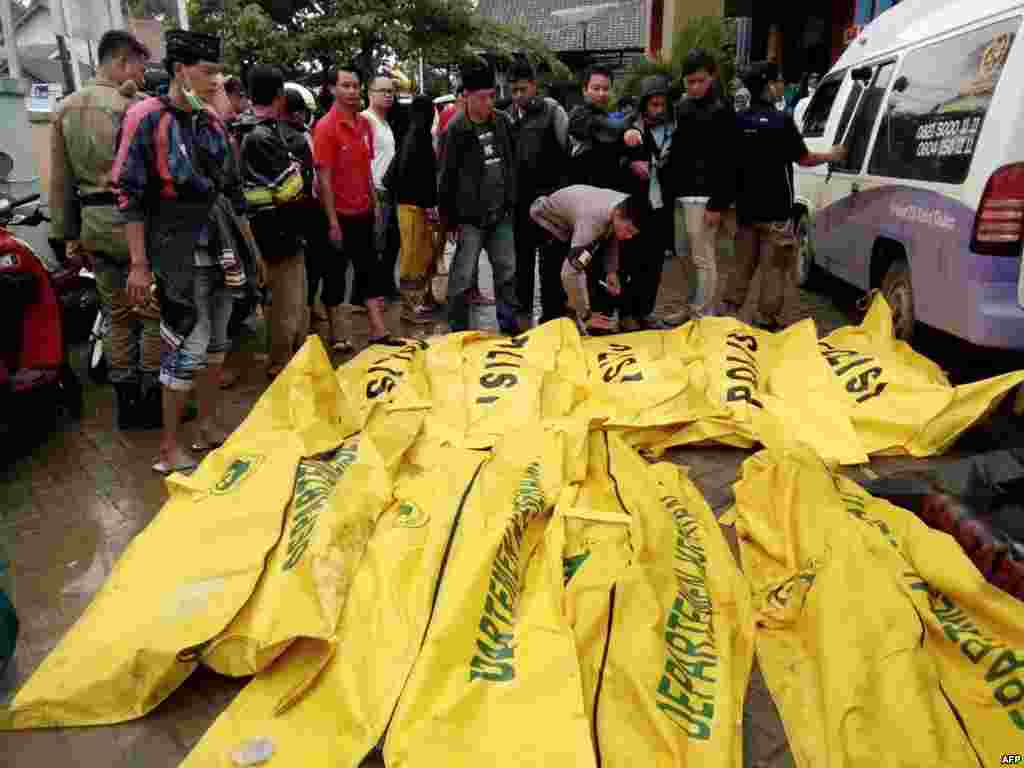 Bodies of victims recovered along Carita beach are placed in body bags, Dec. 23, 2018, after the area was hit by a tsunami Saturday following an eruption of the Anak Krakatoa volcano.