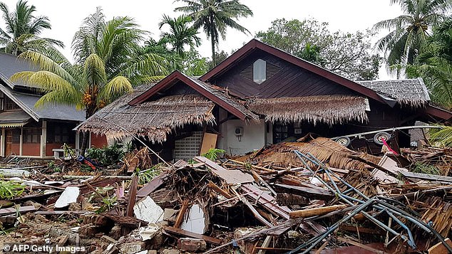 Damaged buildings and debris are seen in Carita after the area was hit by a tsunami (pictured today)