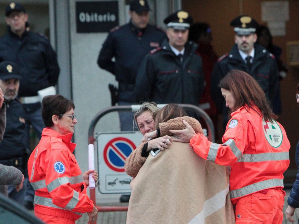 PHOTO: Relatives and friends comfort each others outside the morgue in Corinaldo, Italy, Dec. 8, 2018.