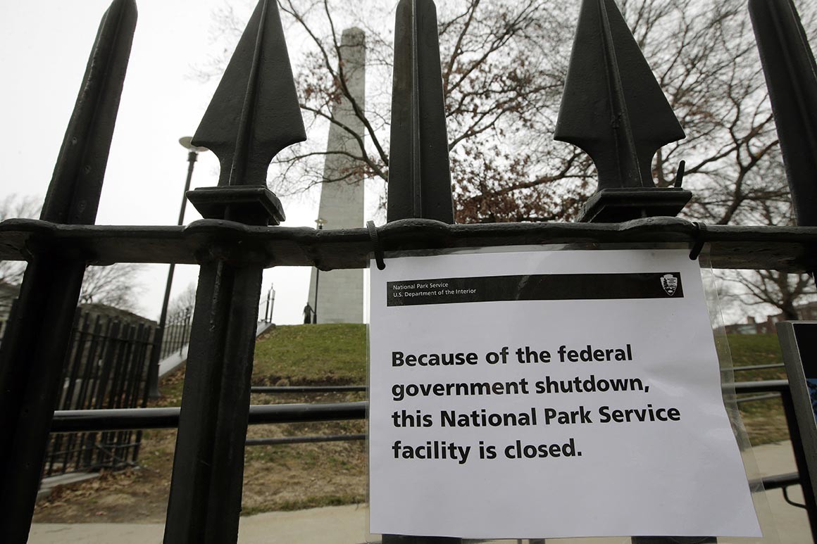 A sign is posted on a fence near an entrance to the Bunker Hill Monument