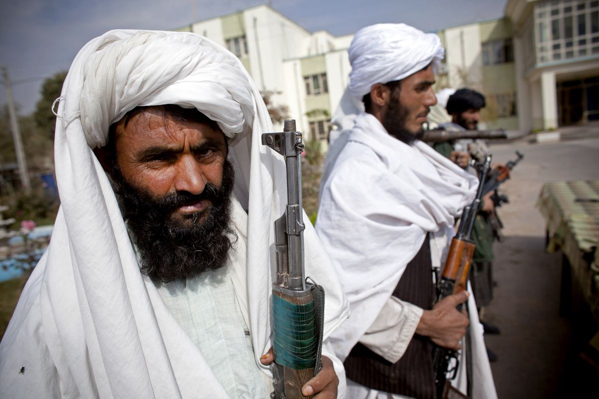 Surrendering Taliban militants stand with their weapons as they are presented to the media on November 4, 2010 in Herat, Afghanistan.