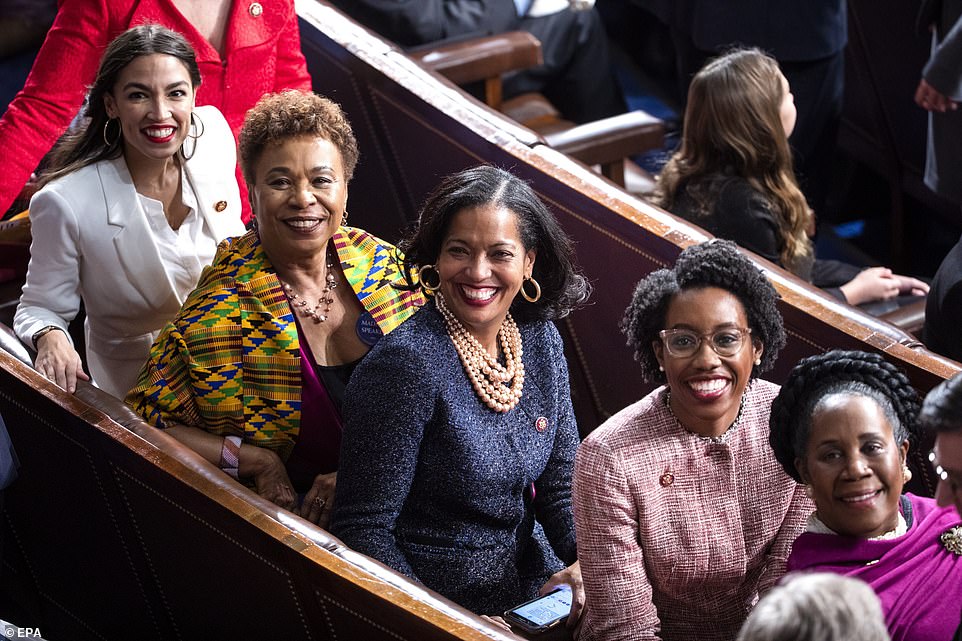 Meet the new boss: Alexandria Ocasio-Cortez, Barbara Lee , Jahana Hayes, Lauren Underwood, and Sheila Jackson Lee turn round to watch Nancy Pelosi enter the House chamber - on her way to becoming Speaker